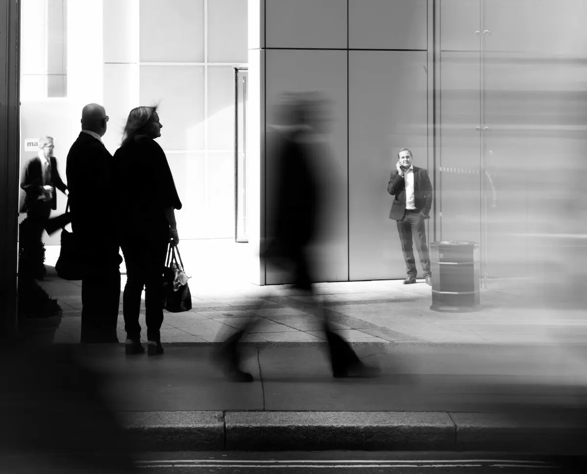 Blurred city pedestrians with phone and walking motion