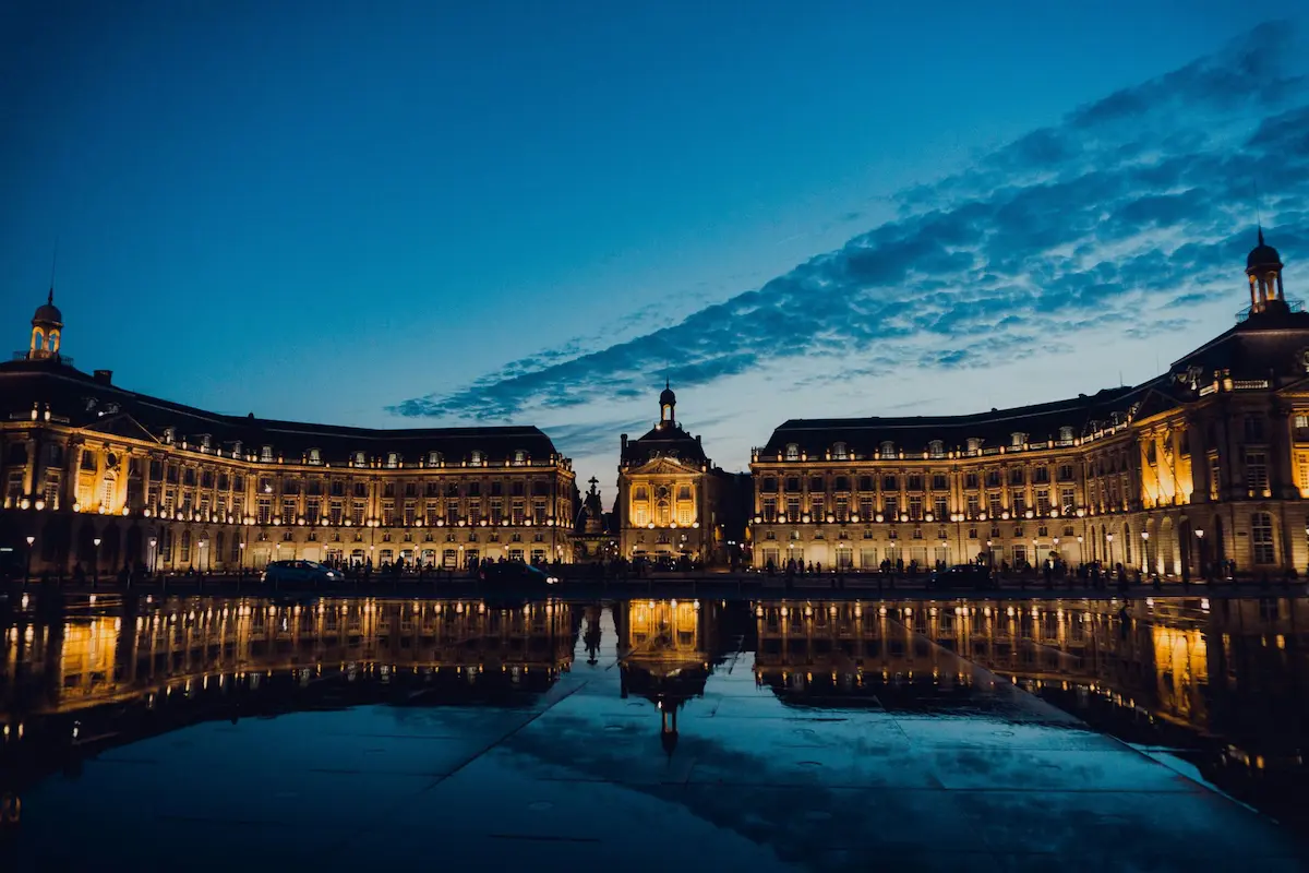 Bordeaux square reflecting lights in evening sky