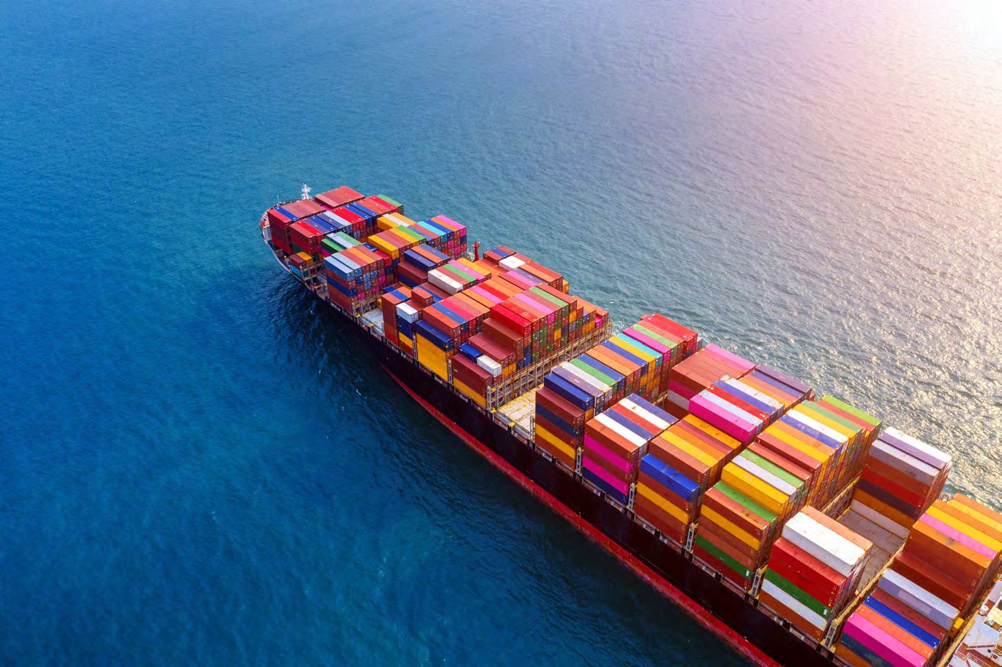 Cargo ship with colorful containers at sea.