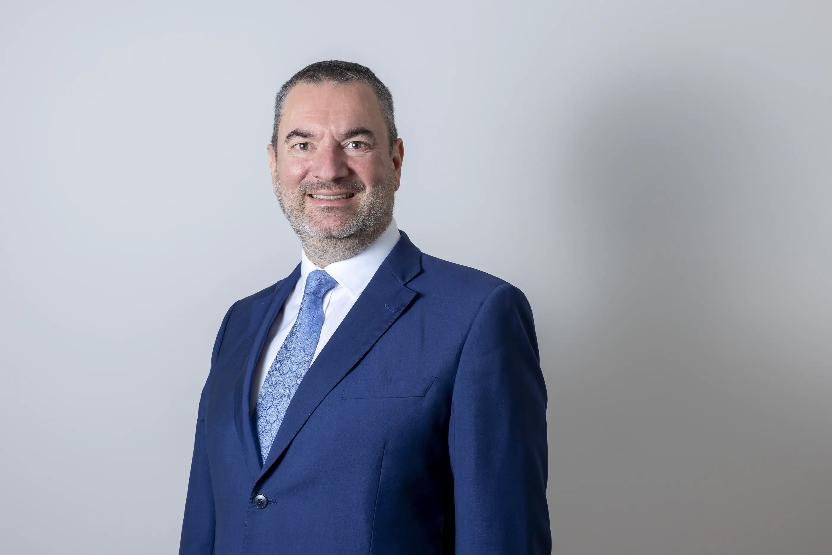 Smiling man in blue suit and tie