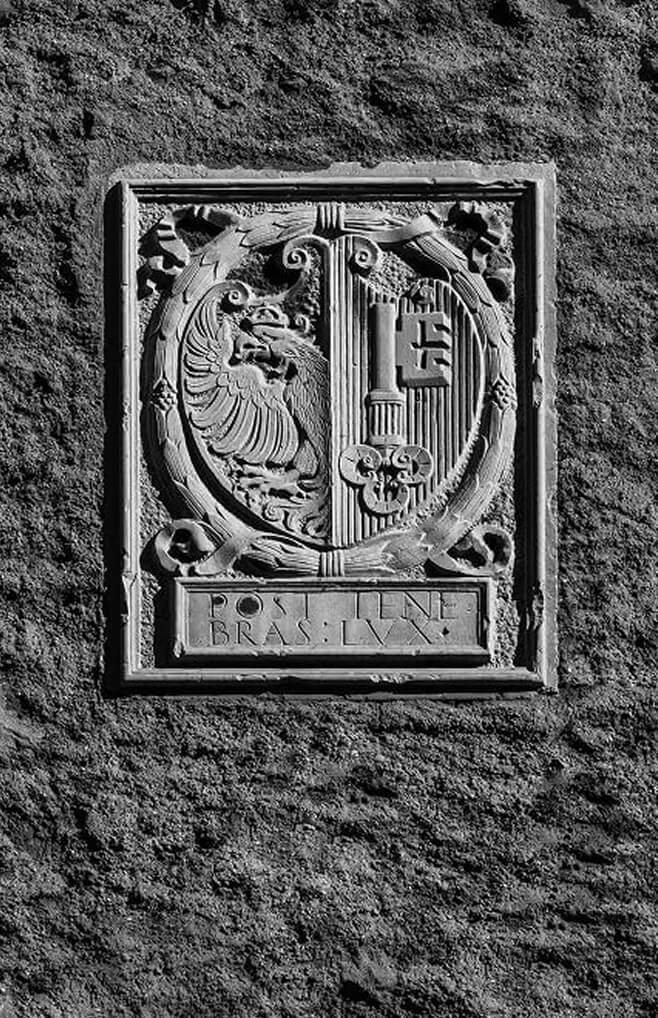 Stone relief of eagle and key emblem.